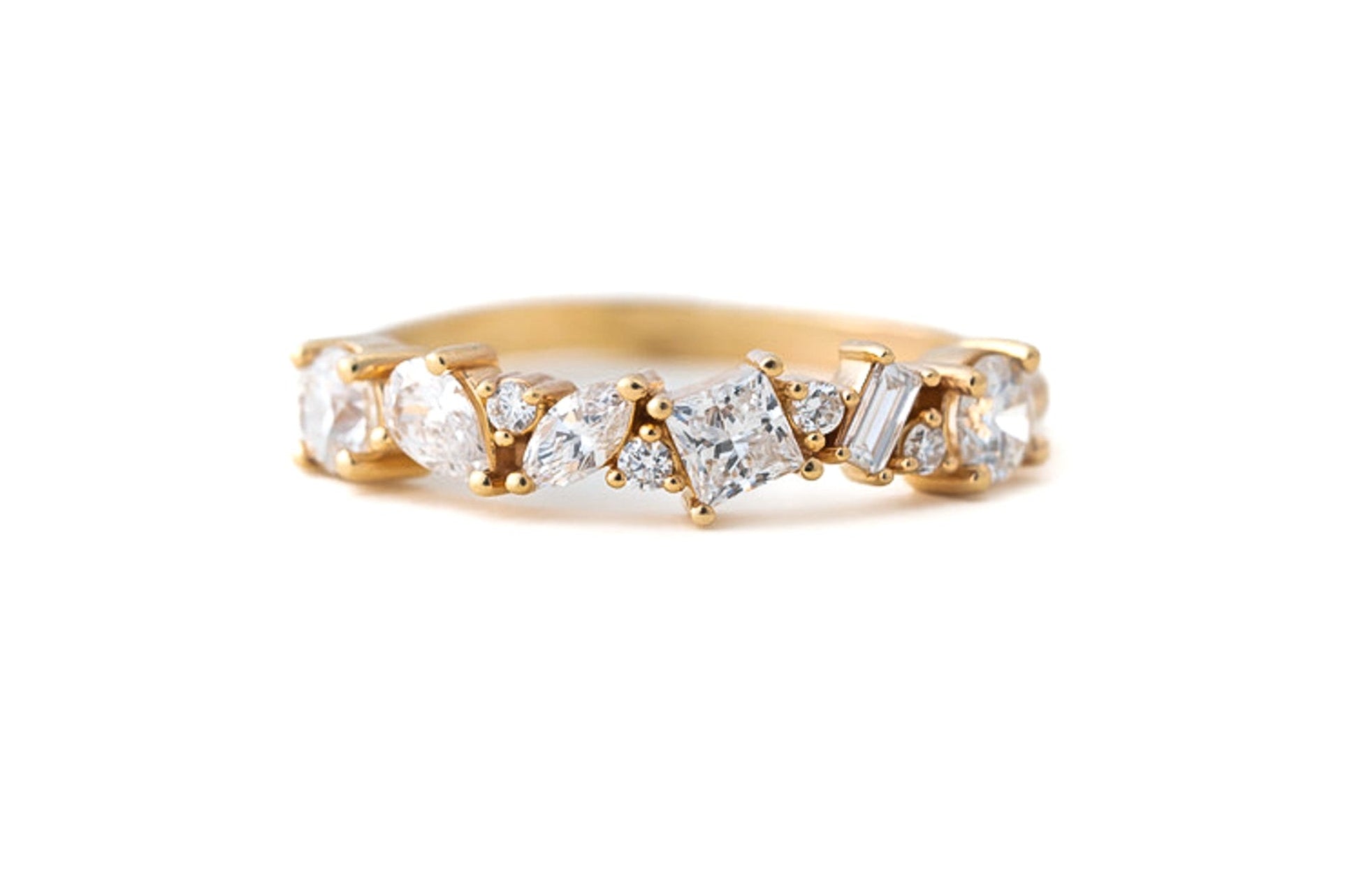 Gold ring with diamonds on a white background