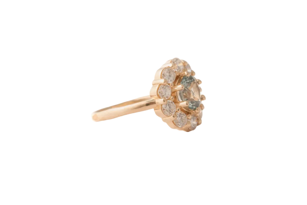 Rose gold ring with diamond stones on a white background