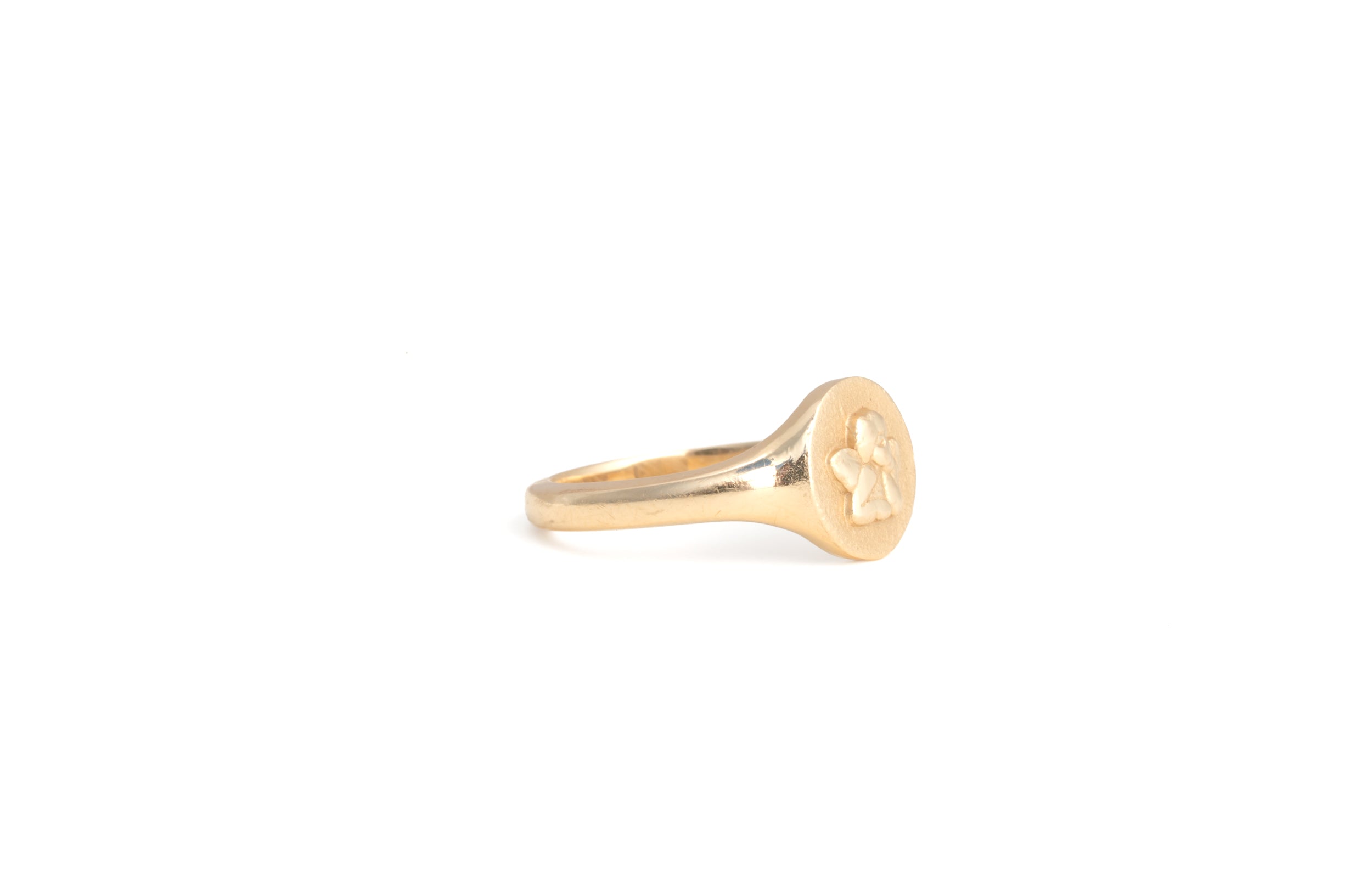 side view of gold signet ring with angel cherub