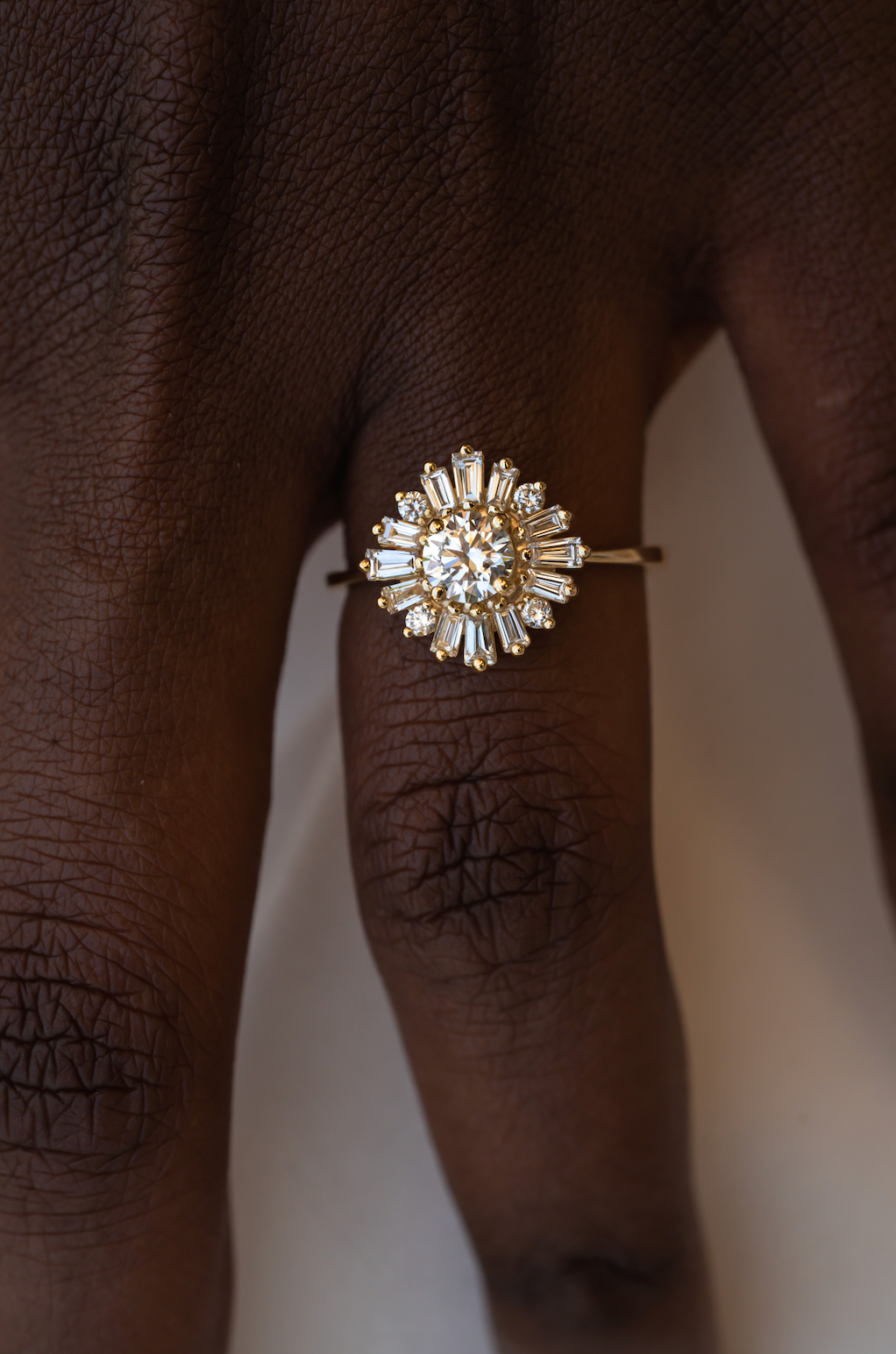 A ballerina style diamond ring on a person's finger