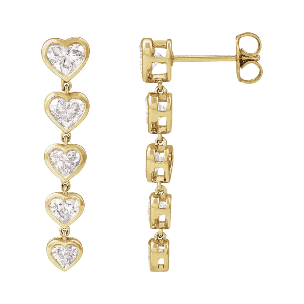 Gold heart-shaped earrings with clear gemstones on a white background