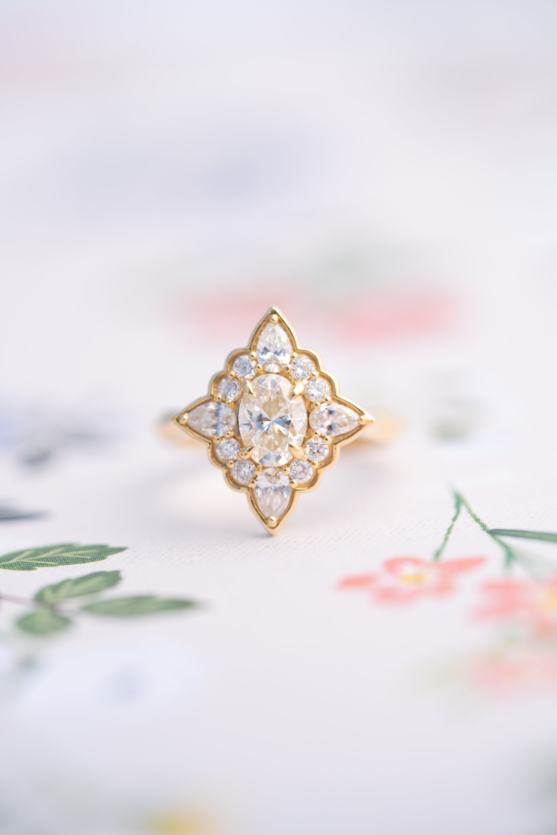 Gold ring with diamond-like stones on a soft, blurred background