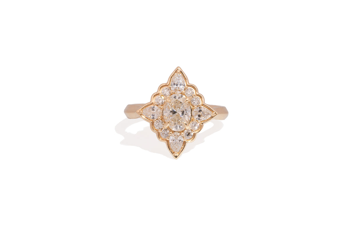 Gold ring with diamond accents on a white background