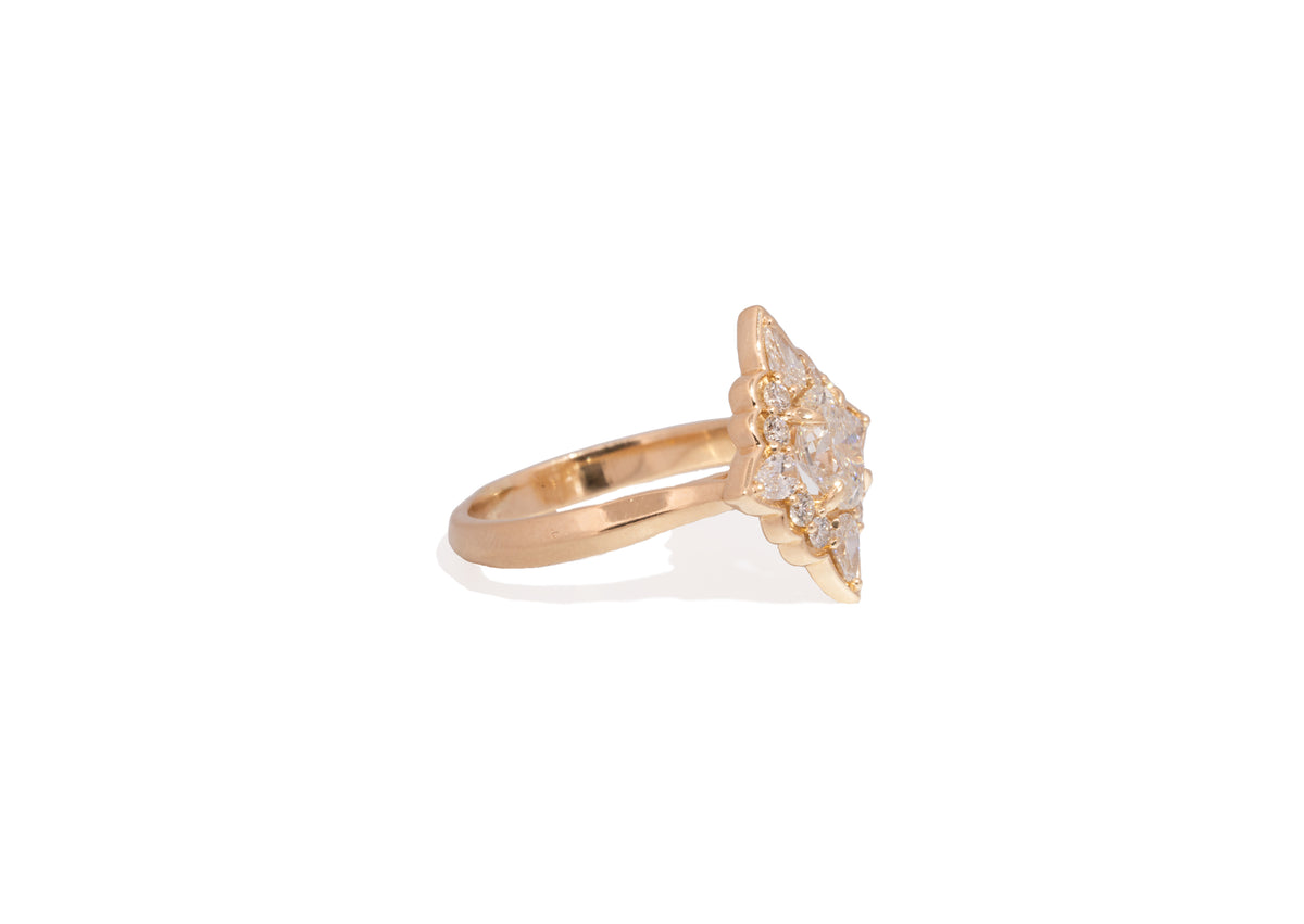 yellow gold ring with diamond accents on a white background