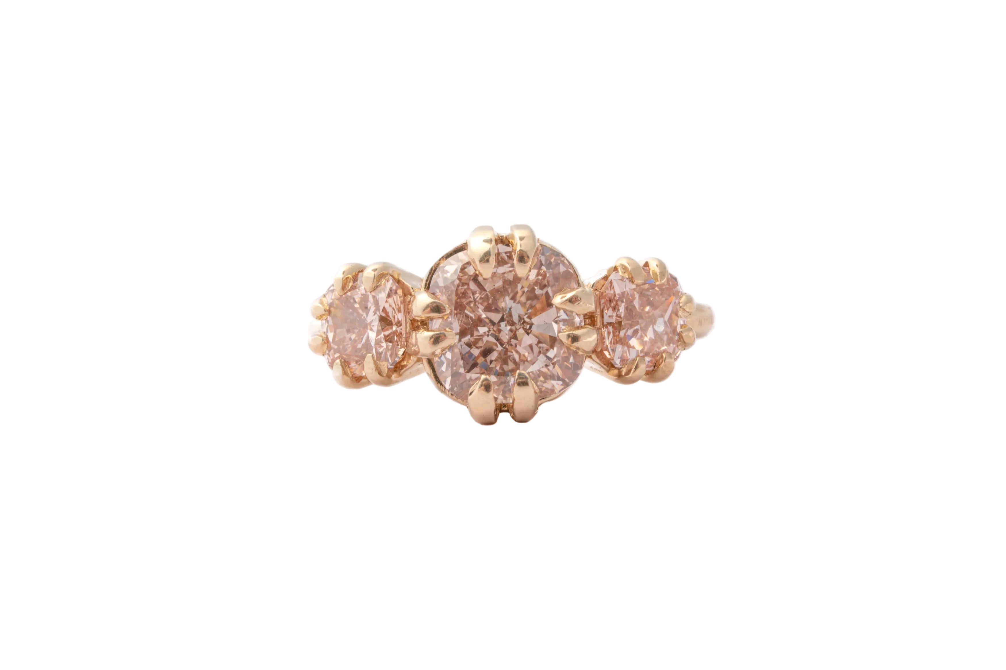 Rose gold ring with pink diamonds on a white background