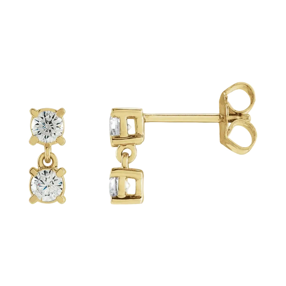 Gold earrings with clear gemstones on a white background
